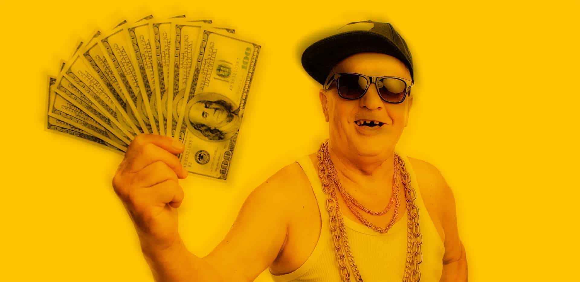 toothless old man in hip hop outfit holding cash