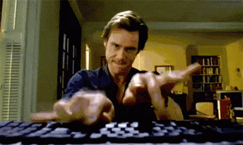 Jim Carrey furiously typing on a keyboard