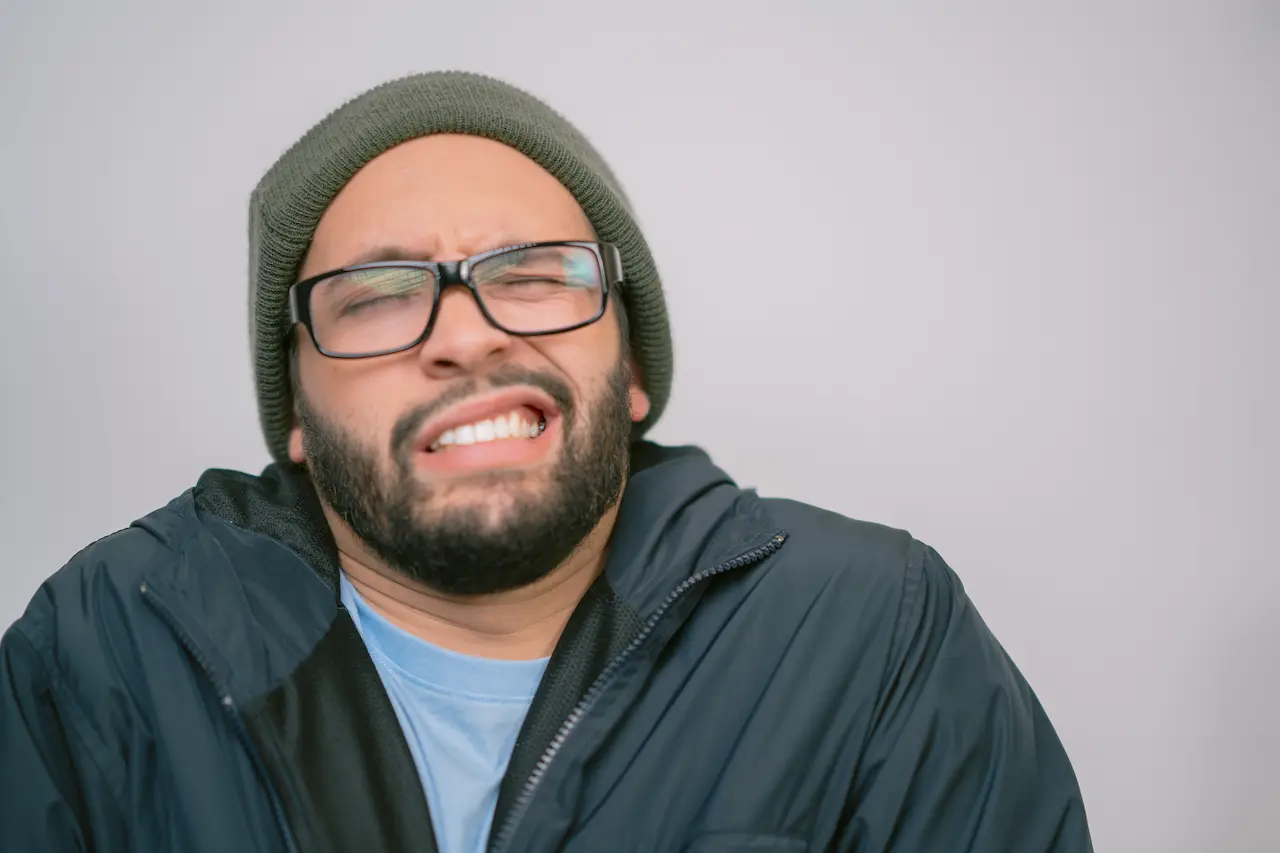 Young man making a funny face with eyes closed 2025 03 08 02 00 14 utc